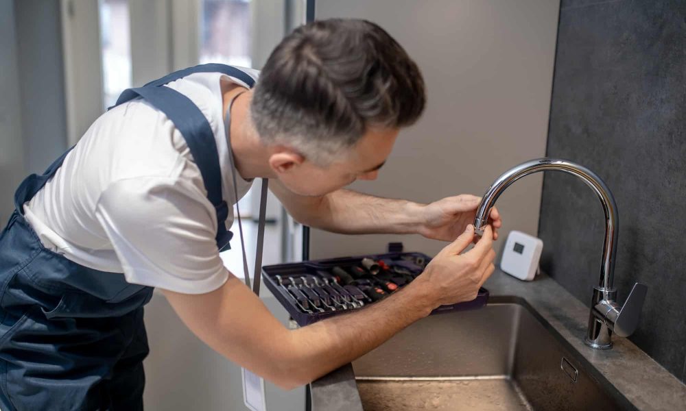 man-spinning-faucet-aerator-on-spout-pipe.jpg
